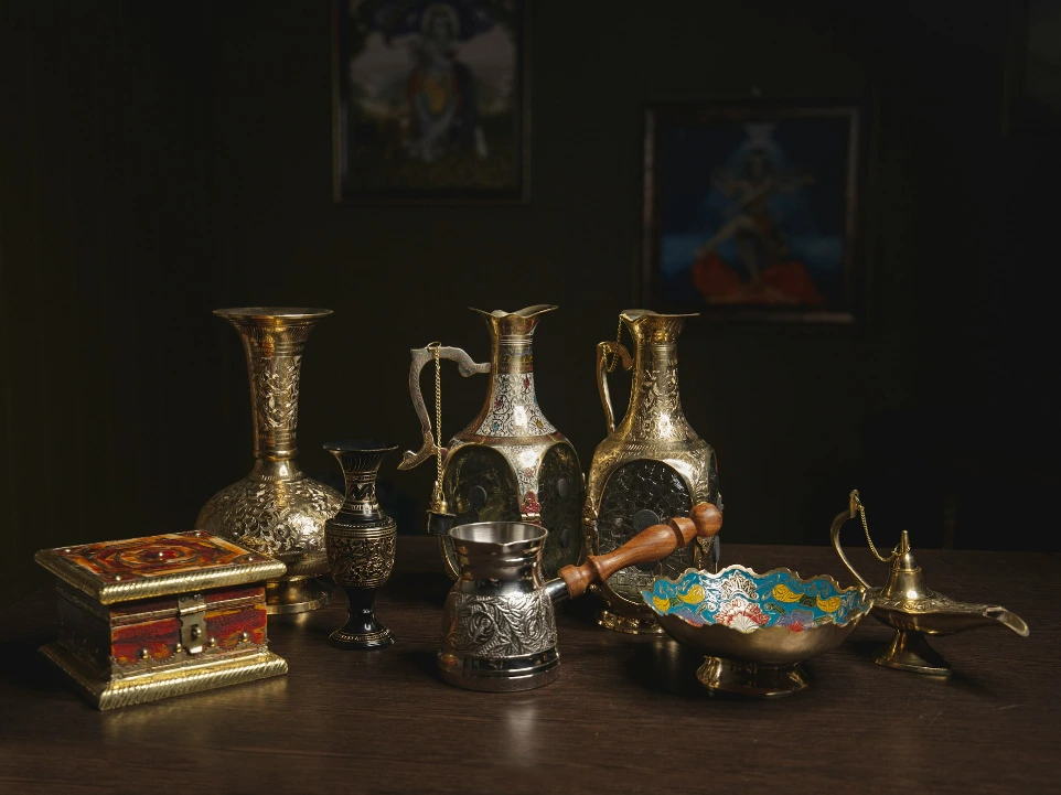 brass vase on brown wooden table